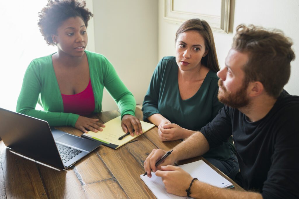 3 worried investors talk at a table.jpg